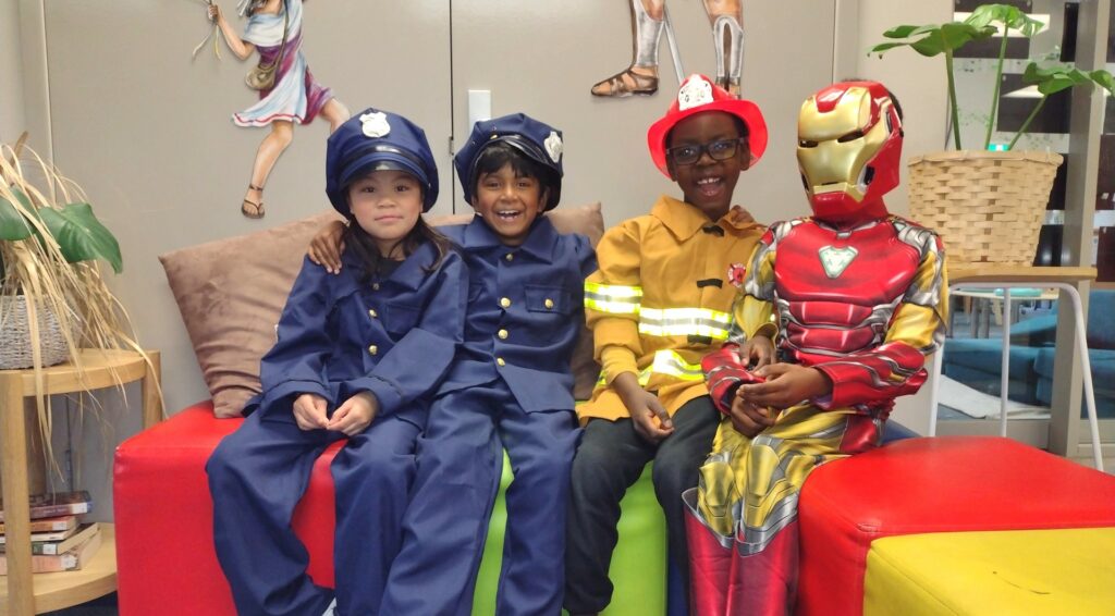 Children disguised as policemen, firemen and iron men